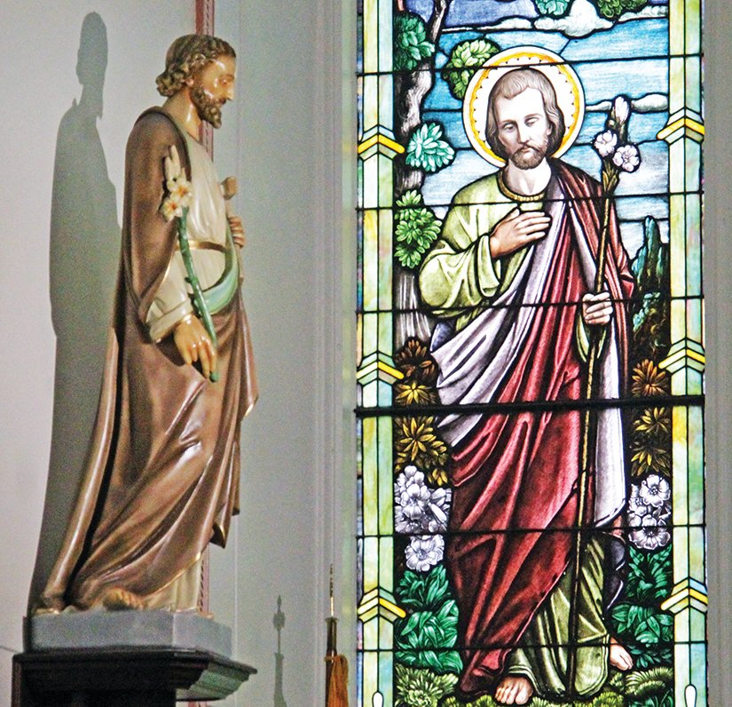 Statue and stained glass image of St. Joseph, in St. Joseph Church in Edina.